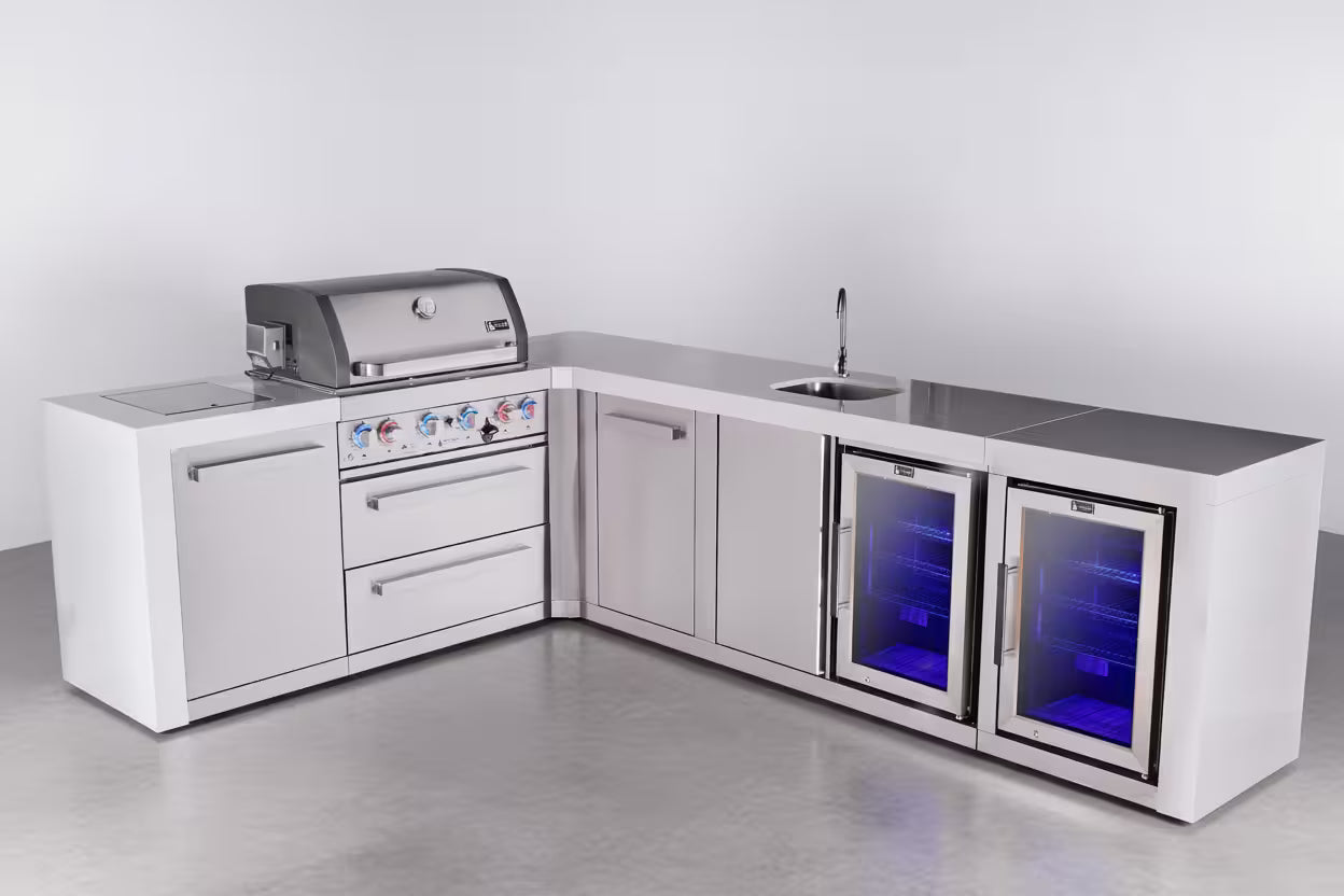 Outdoor kitchen with grill, sink, and refrigerator on a gray floor and white wall background